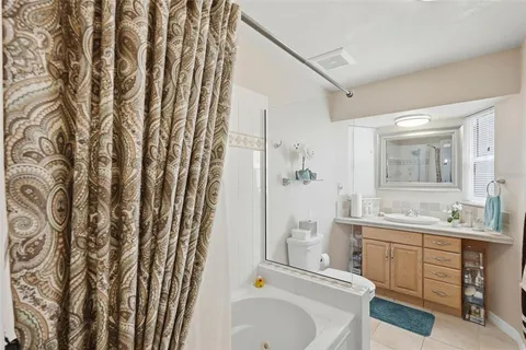 a bathroom with a sink a toilet and shower curtain