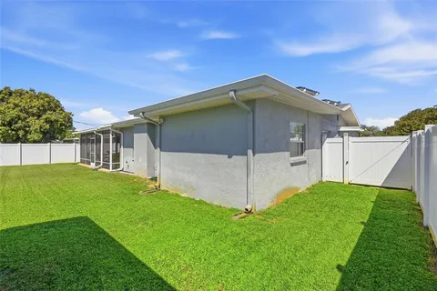 a house with green field in front of it