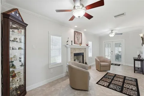 a living room with furniture a fireplace and a chandelier
