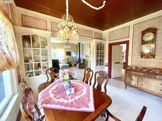 a living room with furniture windows and a chandelier