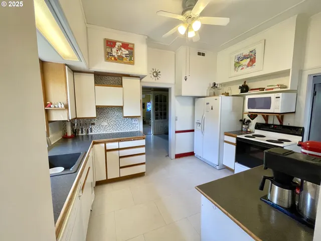 a kitchen with stainless steel appliances granite countertop a stove and a refrigerator