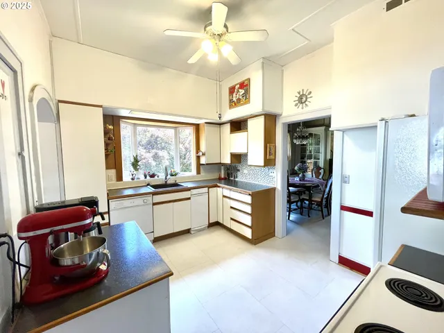 a kitchen with a refrigerator and a stove
