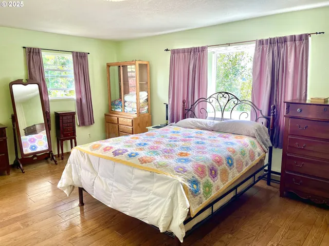 a bed sitting in a bedroom next to a window