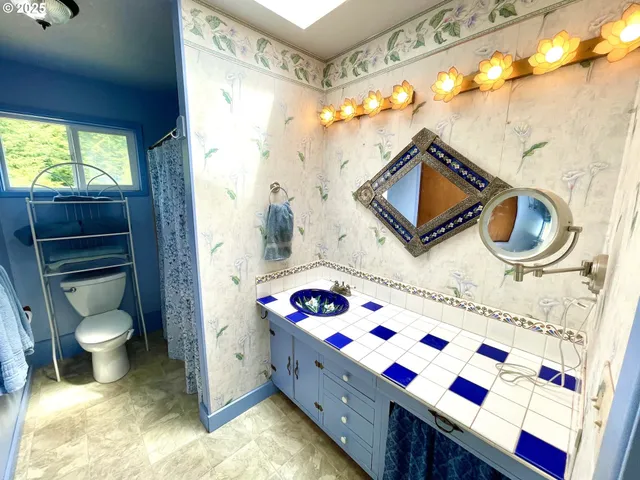 a bathroom with a sink a toilet and bathtub