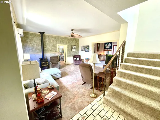 a living room with furniture and a floor to ceiling window