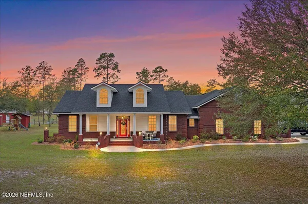 a front view of a house with swimming pool having outdoor seating