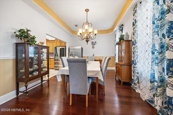 a view of a dining room with furniture and wooden floor