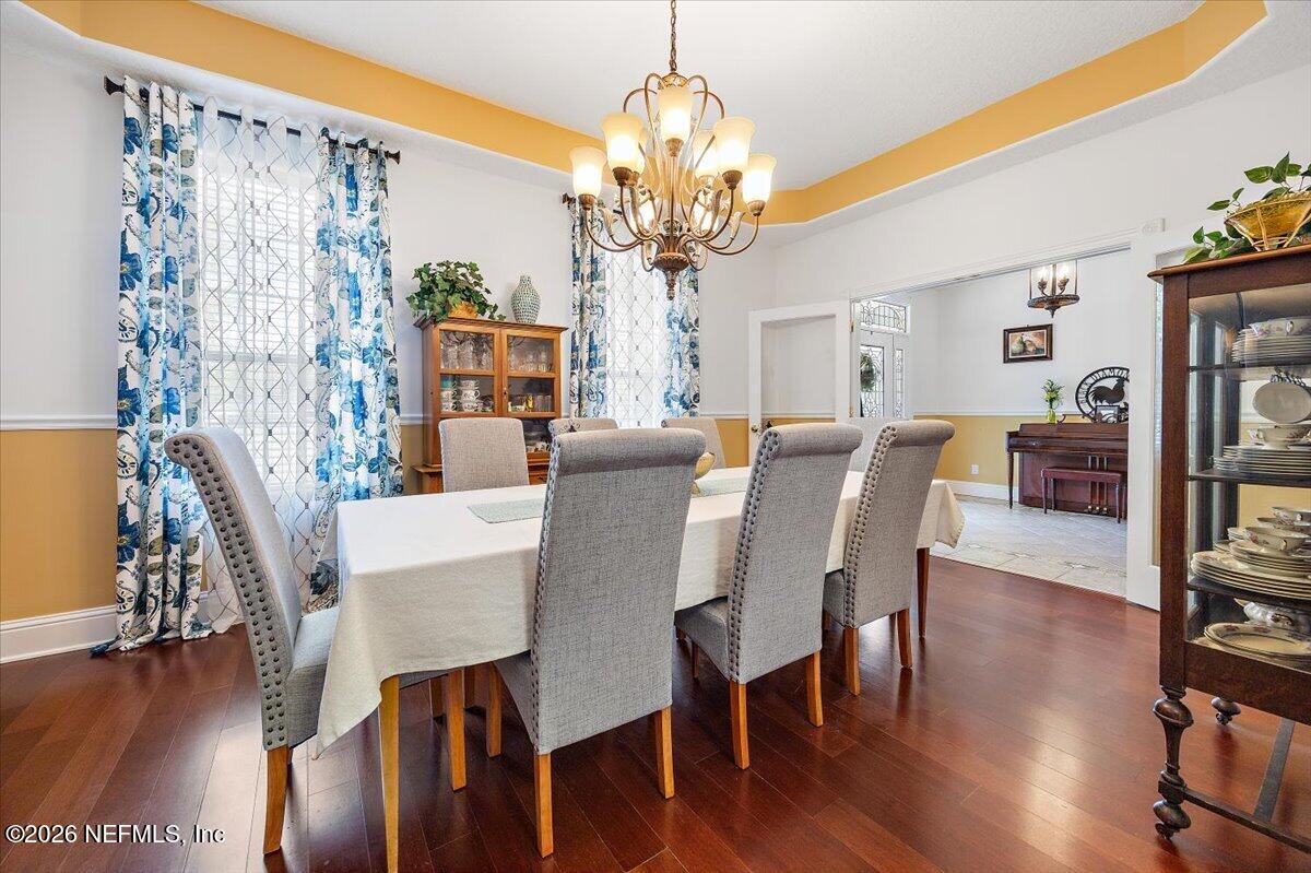 14394 Bob Burnsed Road Glen St. Mary, FL 32040 - Photo 11 of 53 a view of a dining room with furniture wooden floor and chandelier