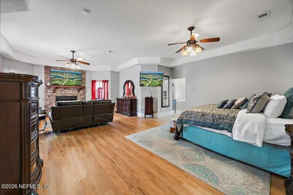 a living room with furniture a large window and a chandelier