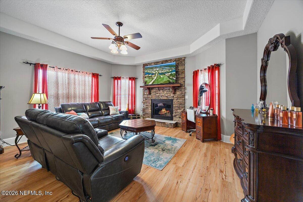 14394 Bob Burnsed Road Glen St. Mary, FL 32040 - Photo 18 of 53 a living room with furniture a fireplace and a flat screen tv