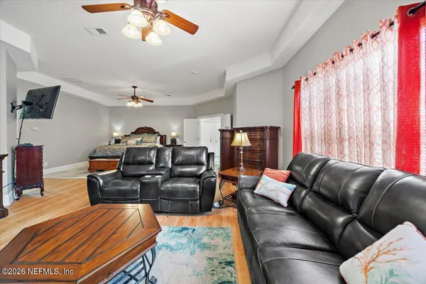 a living room with furniture a fireplace and a flat screen tv