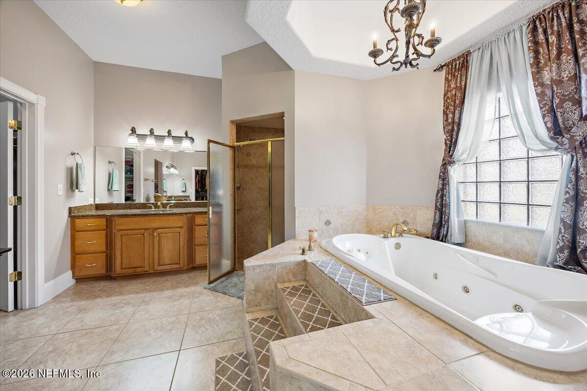 14394 Bob Burnsed Road Glen St. Mary, FL 32040 - Photo 20 of 53 a large spacious bathroom with a double vanity sink a mirror and a bathtub