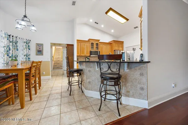 a view of a kitchen with kitchen island dining table and wooden floor