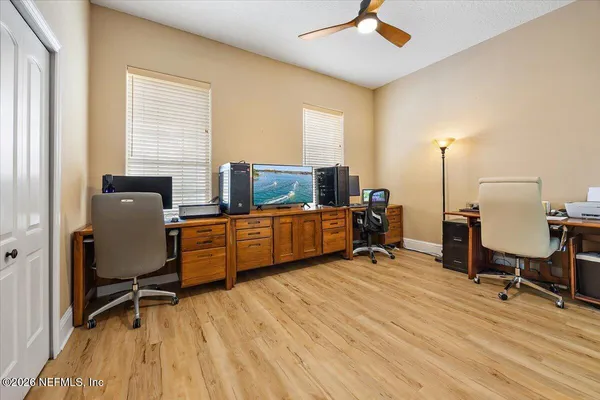a view of a bedroom with furniture and wooden floor