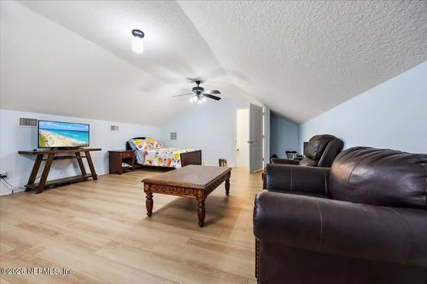 a living room filled with furniture and a large window