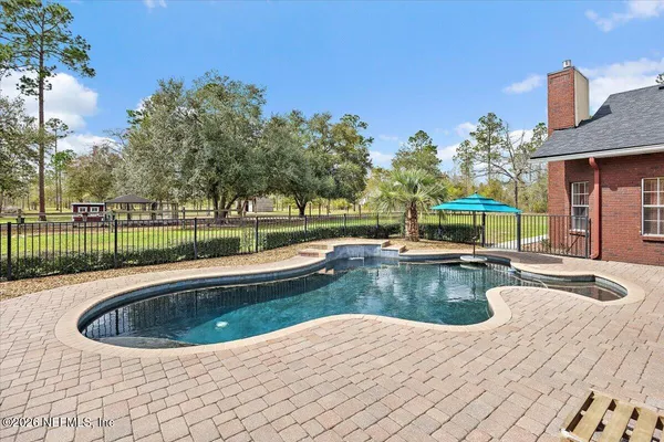 a view of a house with swimming pool and sitting area