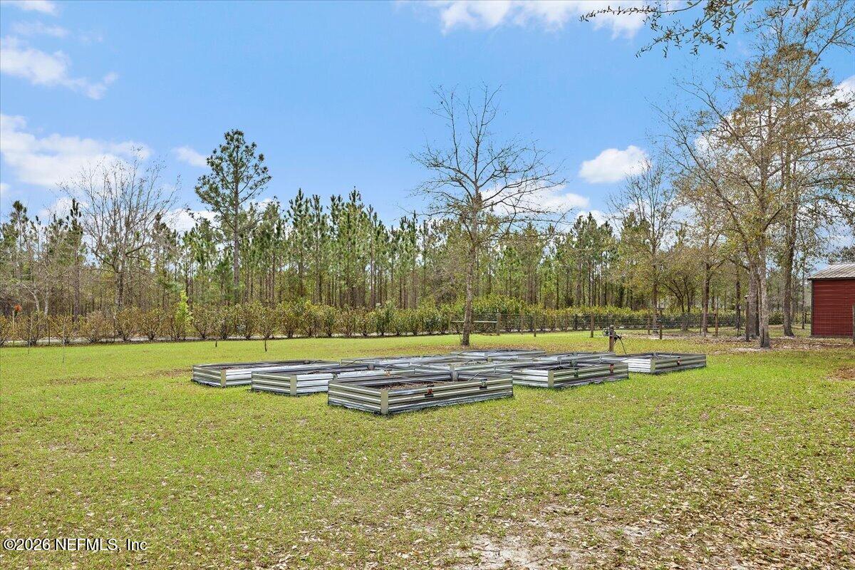 14394 Bob Burnsed Road Glen St. Mary, FL 32040 - Photo 39 of 53 a view of a swimming pool with an outdoor space and seating area