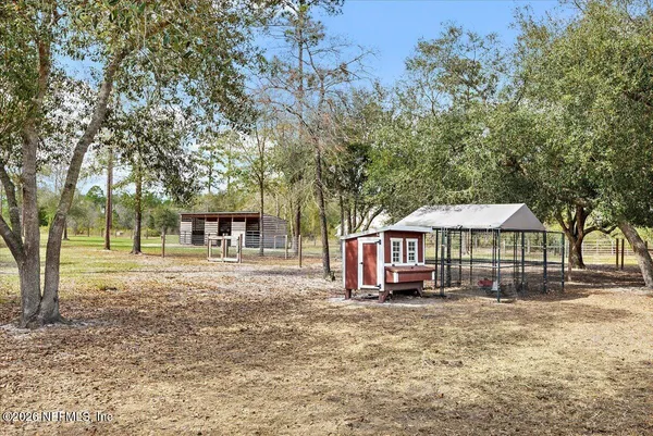 a backyard of a house with barbeque oven table and chairs