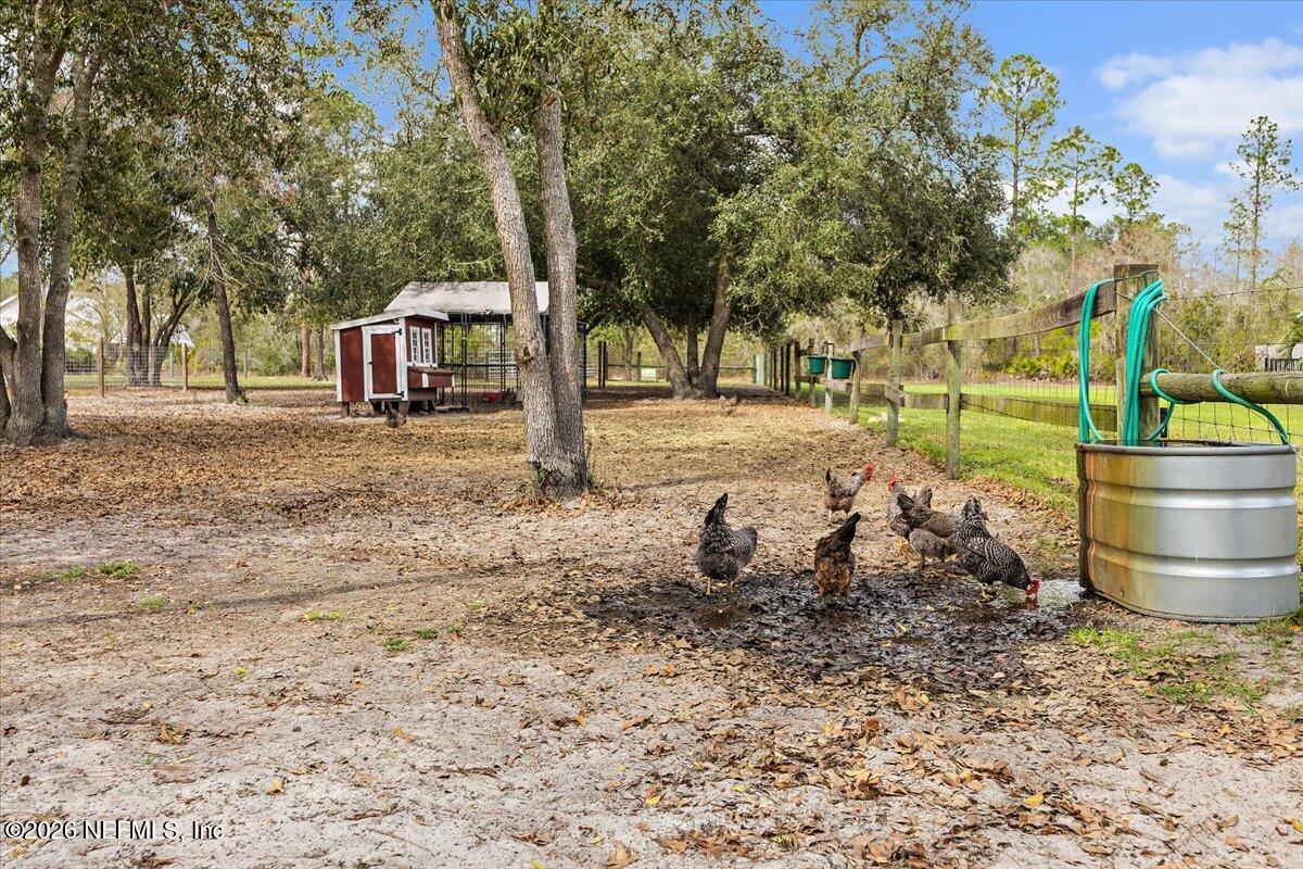 14394 Bob Burnsed Road Glen St. Mary, FL 32040 - Photo 41 of 53 a backyard of a house with barbeque oven table and chairs