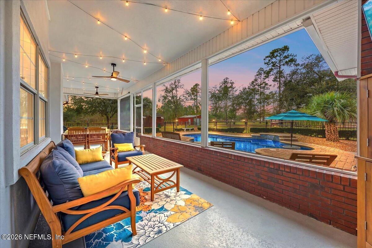 14394 Bob Burnsed Road Glen St. Mary, FL 32040 - Photo 5 of 53 a living room with patio furniture and a floor to ceiling window