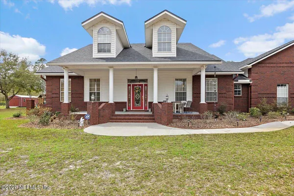 a view of a house with a yard porch and sitting area
