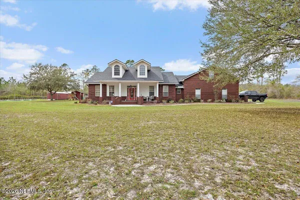 a front view of a building with a garden