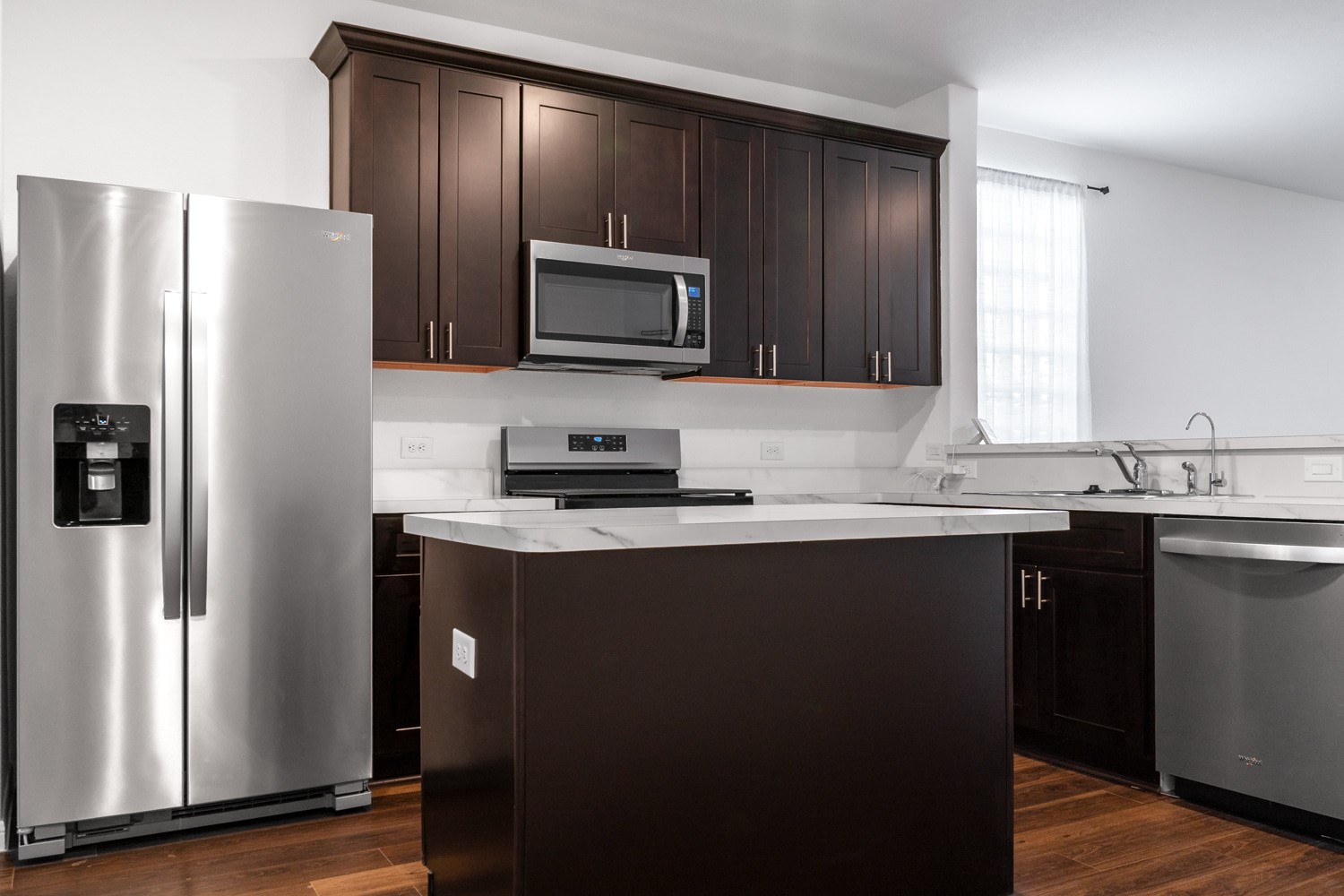 10222 Clearwick Street Houston, TX 77034 - Photo 15 of 28 a kitchen with a sink a microwave a refrigerator and cabinets