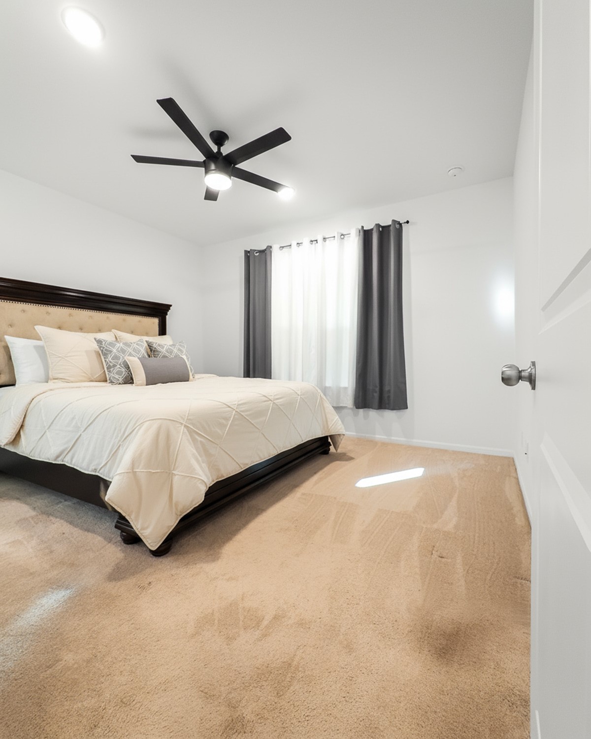 10222 Clearwick Street Houston, TX 77034 - Photo 24 of 28 a bedroom with a large bed and a ceiling fan