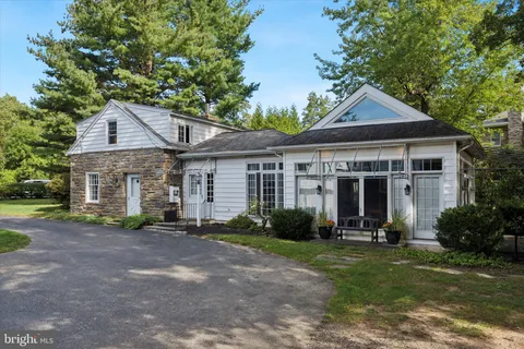 a living room with furniture fireplace and a large window