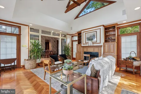 a living room with furniture fireplace and a large window