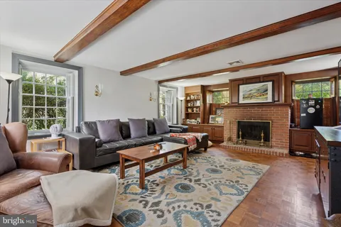 a bedroom with furniture and a large window