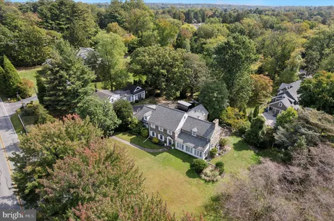 an aerial view of a house with a garden and swimming pool