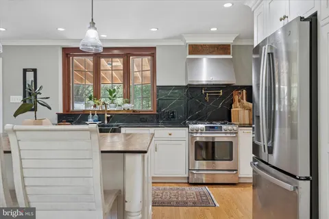 a kitchen with a stove a sink and a refrigerator