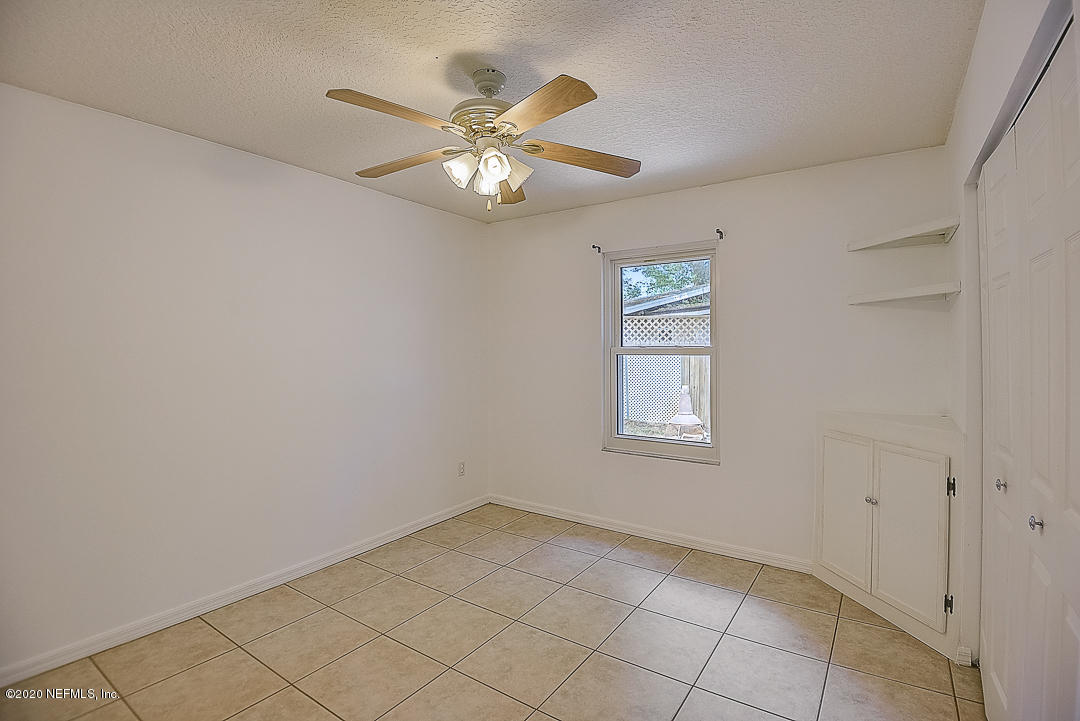 115 Beechwood Road St. Augustine, FL 32086 - Photo 16 of 28 an empty room with windows and fan