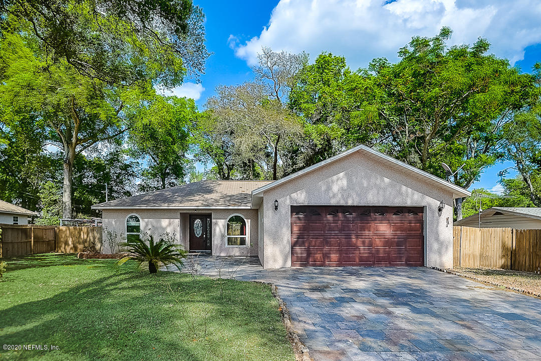 115 Beechwood Road St. Augustine, FL 32086 - Photo 2 of 28 a front view of a house with a garden