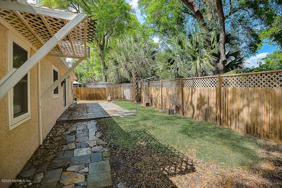 115 Beechwood Road St. Augustine, FL 32086 - Photo 25 of 28 a view of a yard with plants and a large tree