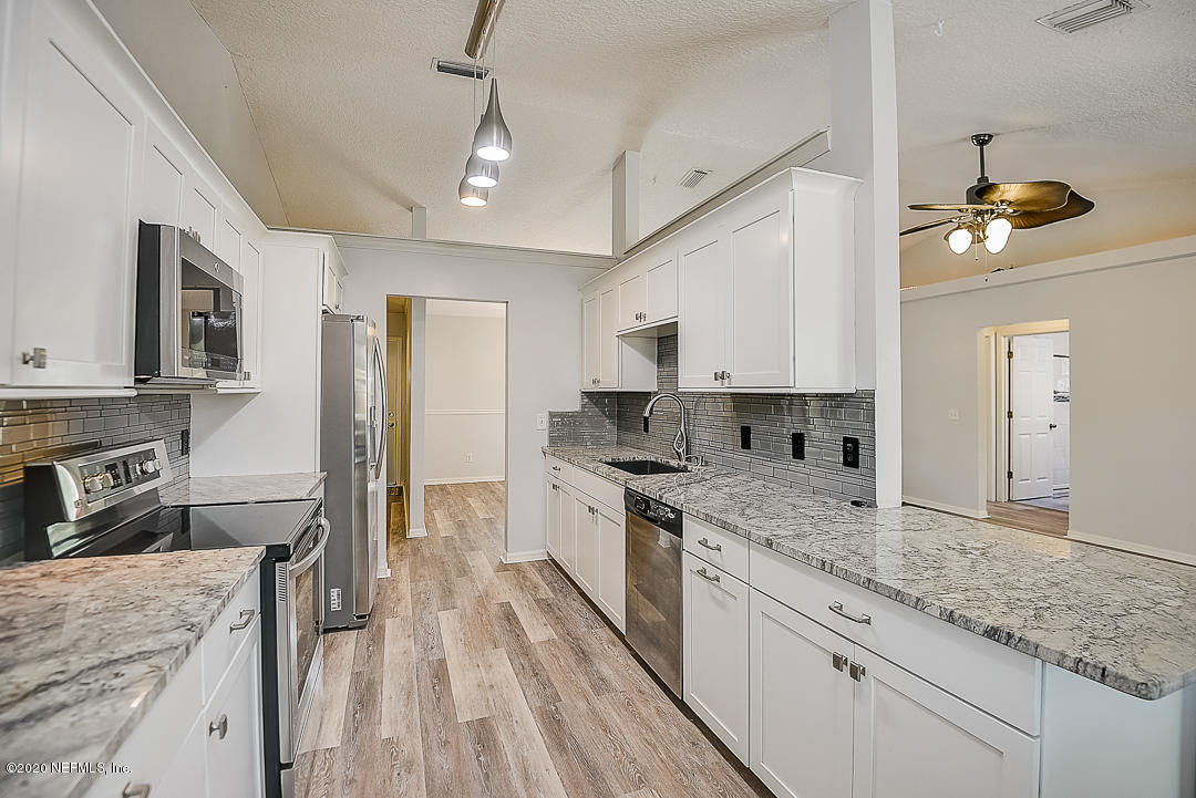 115 Beechwood Road St. Augustine, FL 32086 - Photo 7 of 28 a kitchen with a sink stove and refrigerator
