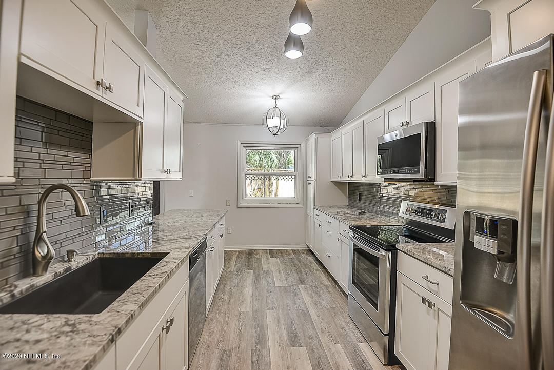 115 Beechwood Road St. Augustine, FL 32086 - Photo 8 of 28 a kitchen with stainless steel appliances granite countertop a sink stove and refrigerator