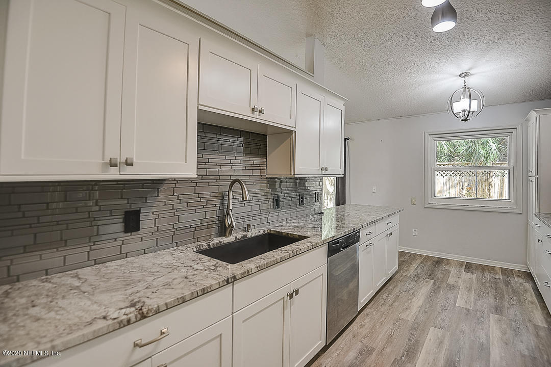 115 Beechwood Road St. Augustine, FL 32086 - Photo 9 of 28 a kitchen with stainless steel appliances granite countertop a sink a stove and cabinets