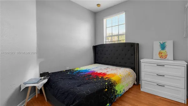 a bedroom with a bed and window