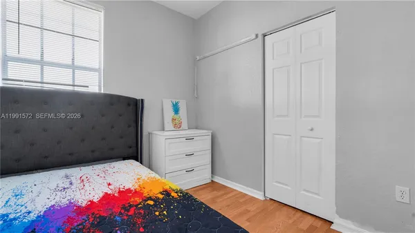 a bedroom with a bed and a dresser