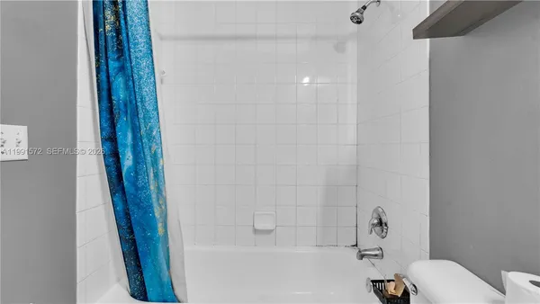 a bathroom with a bathtub and a sink