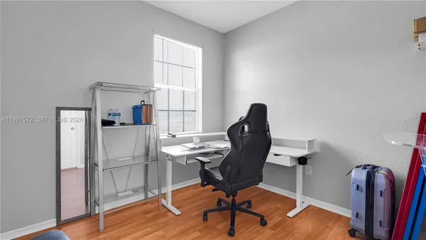 a view of a workspace with furniture and a window