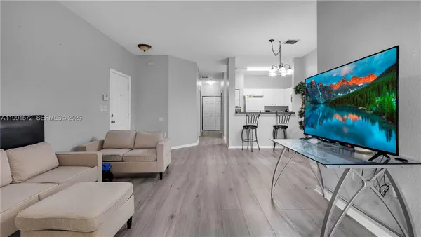 a living room with furniture and a flat screen tv