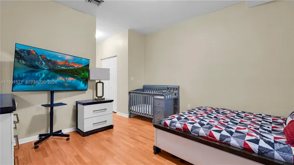 a bedroom with furniture and flat screen tv