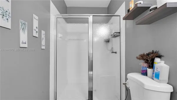 a bathroom with a shower toilet and a shower