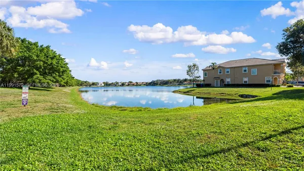 a view of a lake with houses in the background