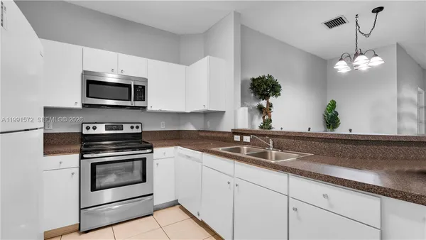 a kitchen with a sink stove and microwave