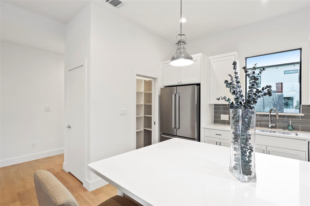 2307 Kirby Street, Unit B Dallas, TX 75204 - Photo 12 of 28 a dining room with chandelier and wooden floor