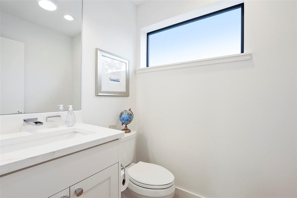 2307 Kirby Street, Unit B Dallas, TX 75204 - Photo 13 of 28 a bathroom with a sink mirror and toilet